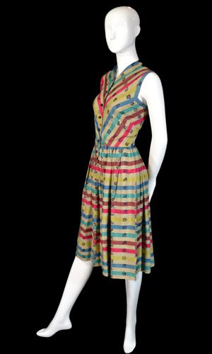 Claire McCardell 's classic style of bias cut striped or plaid bodice combined with a full, straight grain skirt. This time, sleeveless with a v-neck.