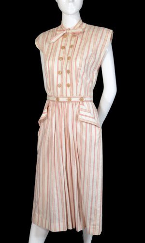 Claire McCardell  striped dress design cut on lenghgrain with a cap sleeve all in-one with bodice, double breasted buttons effect, and contrast pocket and waistband strip detail.
