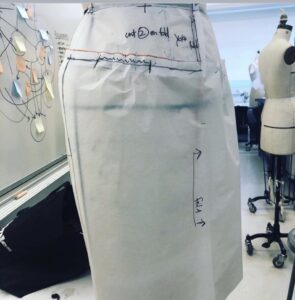 patternmaking and draping foundation course for fashion design! Pinning and testing/ draping a Streight yoke skirt with gathers, pattern draft test on dress form in fashion design studio by Laura Volpintesta at Parsons School of Design.