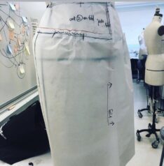 patternmaking and draping foundation course for fashion design! Pinning and testing/ draping a Streight yoke skirt with gathers, pattern draft test on dress form in fashion design studio by Laura Volpintesta at Parsons School of Design.